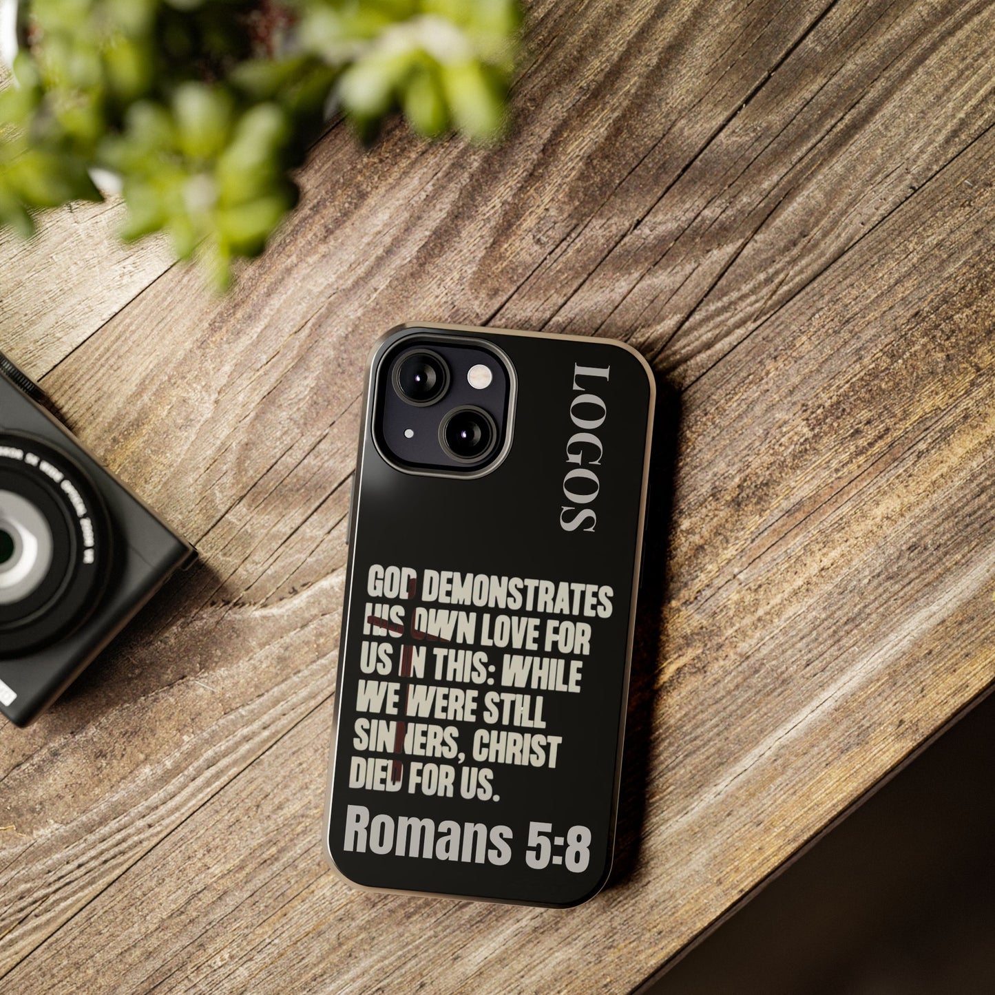 Logos Romans 5:8 phone case with inspirational Bible verse design on black protective cover