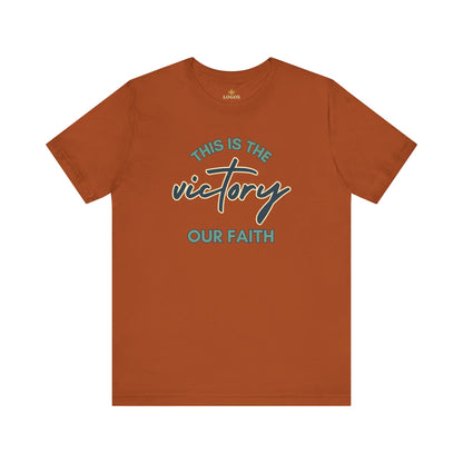 Logos This Is The Victory T-shirt in burnt orange color with faith-themed text design