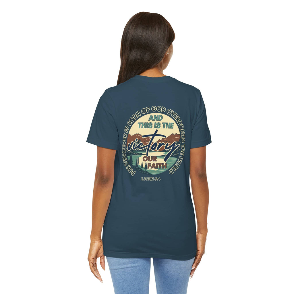 Logos This Is The Victory T-shirt in indigo blue with inspirational faith graphic worn by woman from back