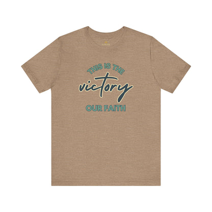 Logos tan T-shirt with This Is The Victory T-shirt text and cross design for faith
