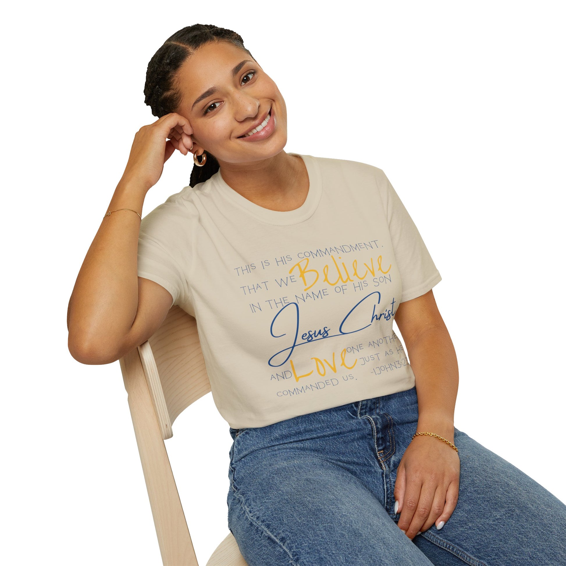 Logos Love One Another shirt with inspirational religious text worn by smiling woman sitting on chair