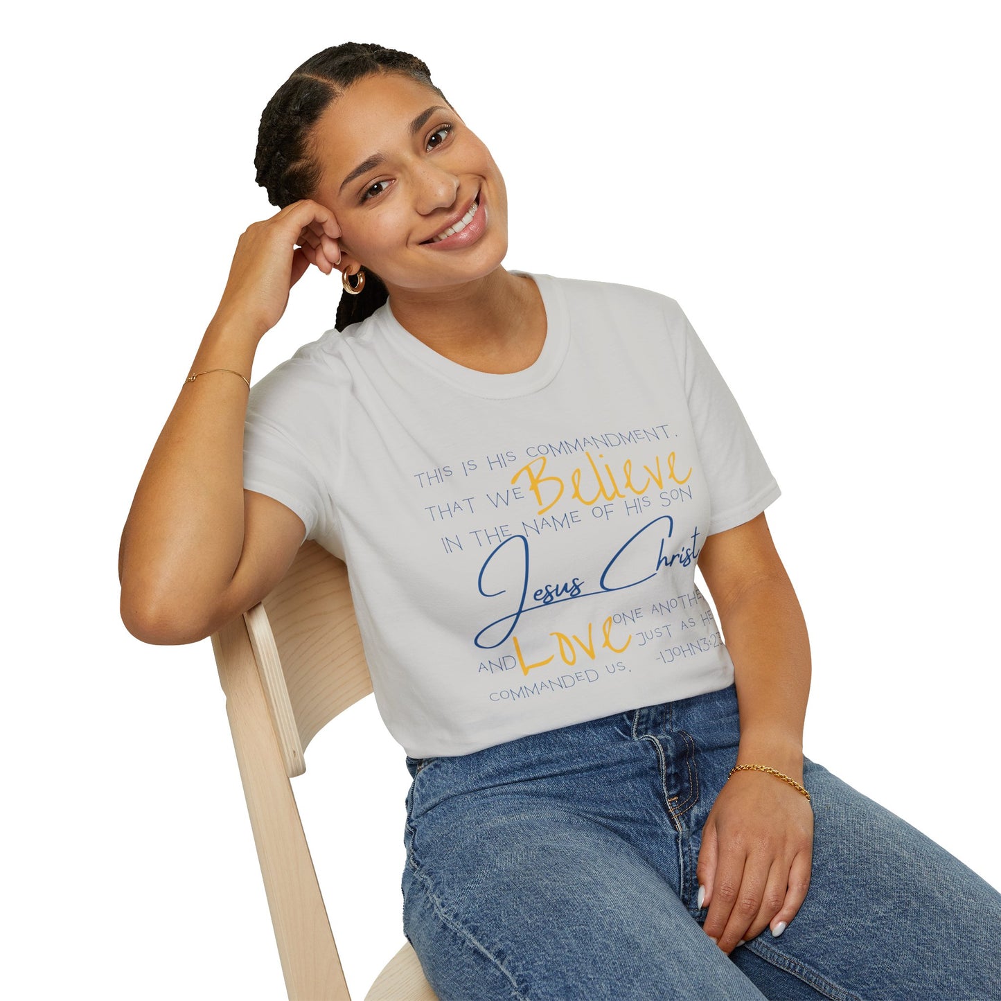 Logos Love One Another shirt in white with faith-inspired text worn by a woman seated on a chair