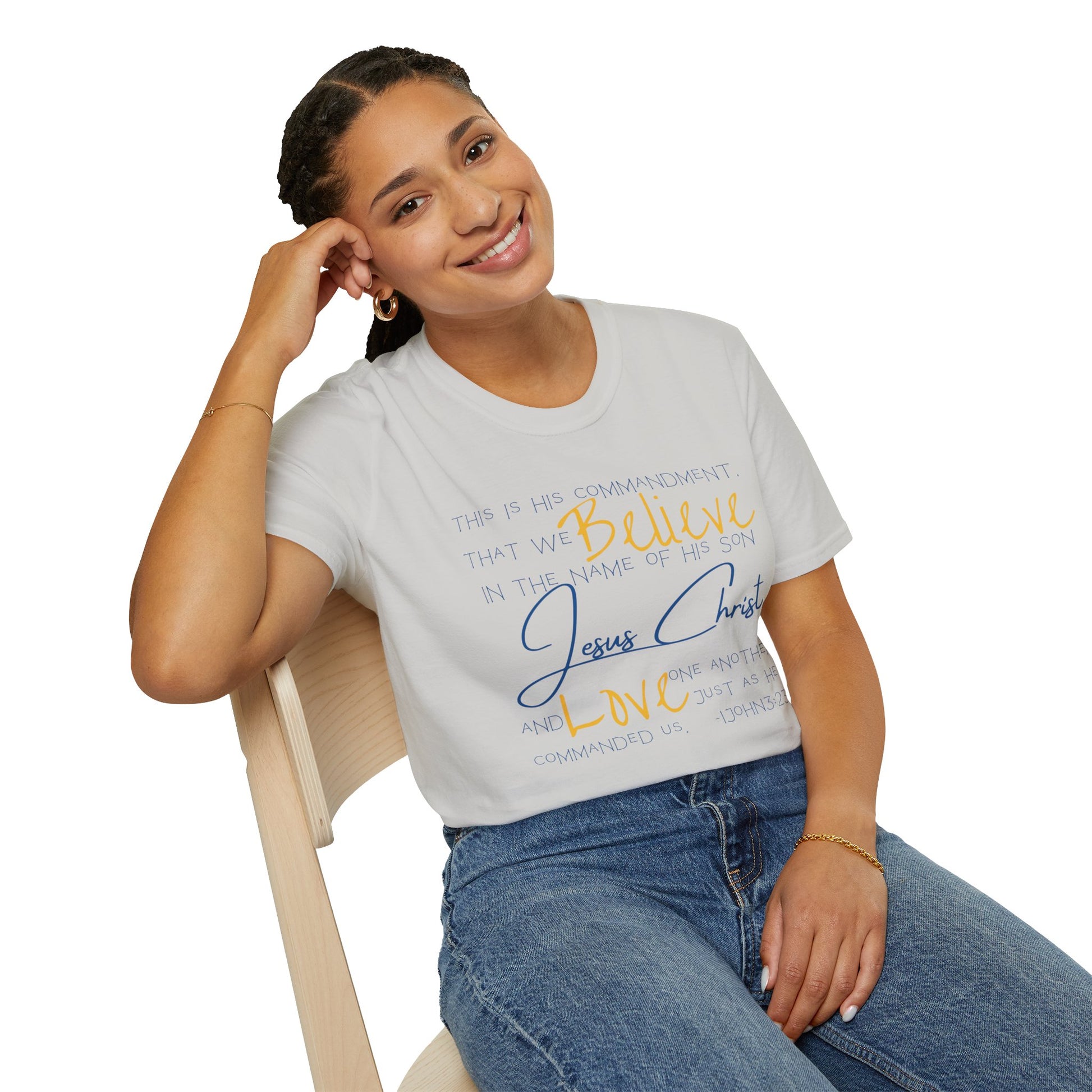Logos Love One Another shirt in white with faith-inspired text worn by a woman seated on a chair