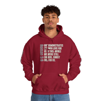 Cardinal Red Romans 5:8 faith hoodie with biblical text design worn by male model