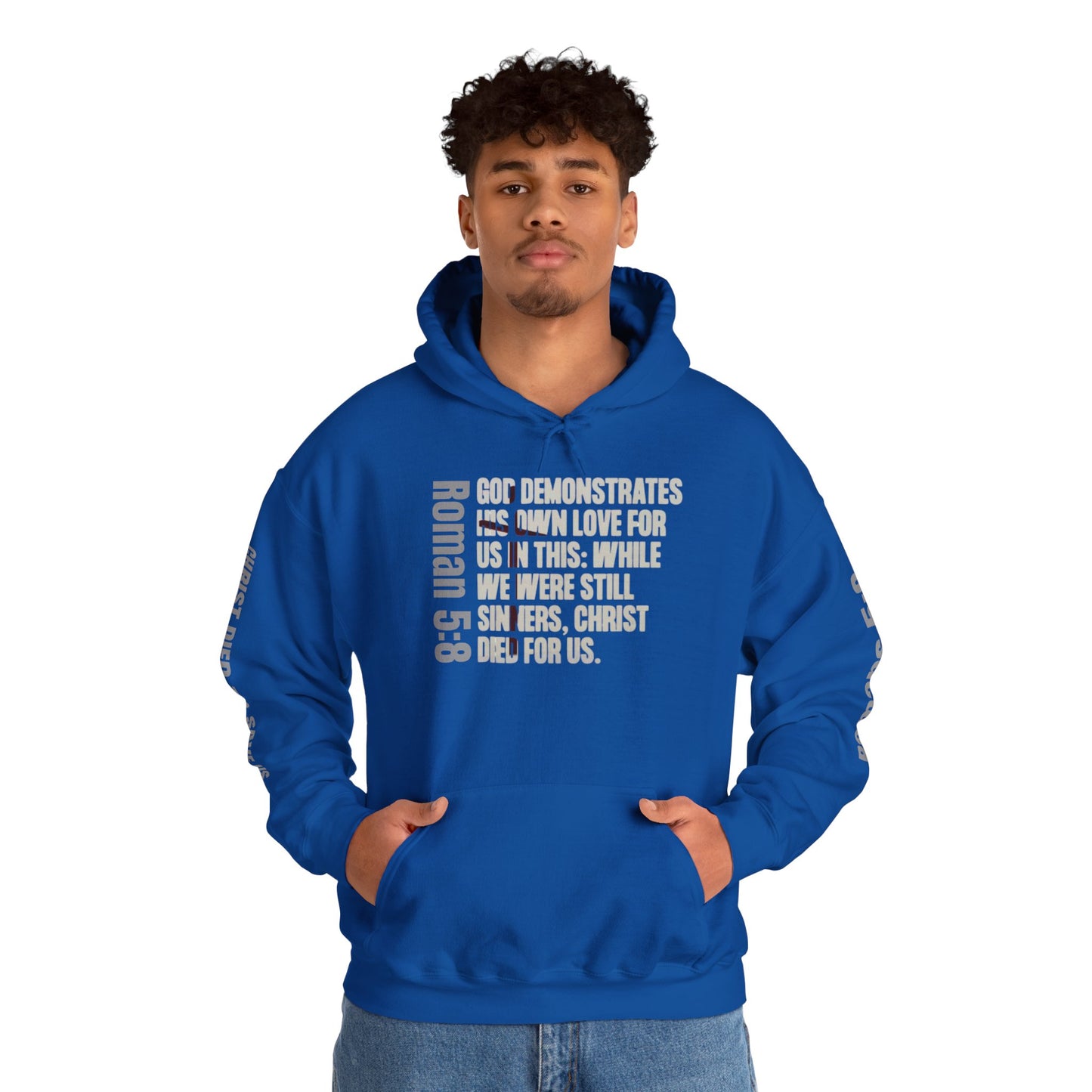 Logos Co. blue Romans 5:8 faith hoodie with scripture text worn by man with hands in pockets