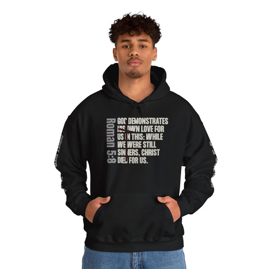 Black Romans 5:8 hoodie from Logos featuring scripture text design worn by a male model