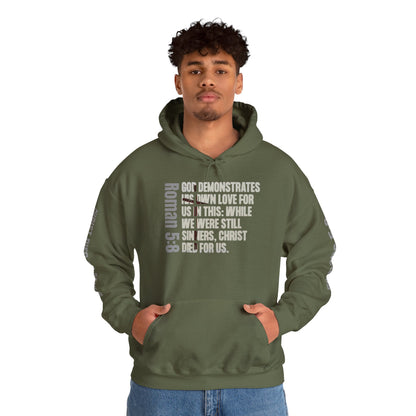 Romans 5:8 hoodie in military green with biblical text design on front worn by male model