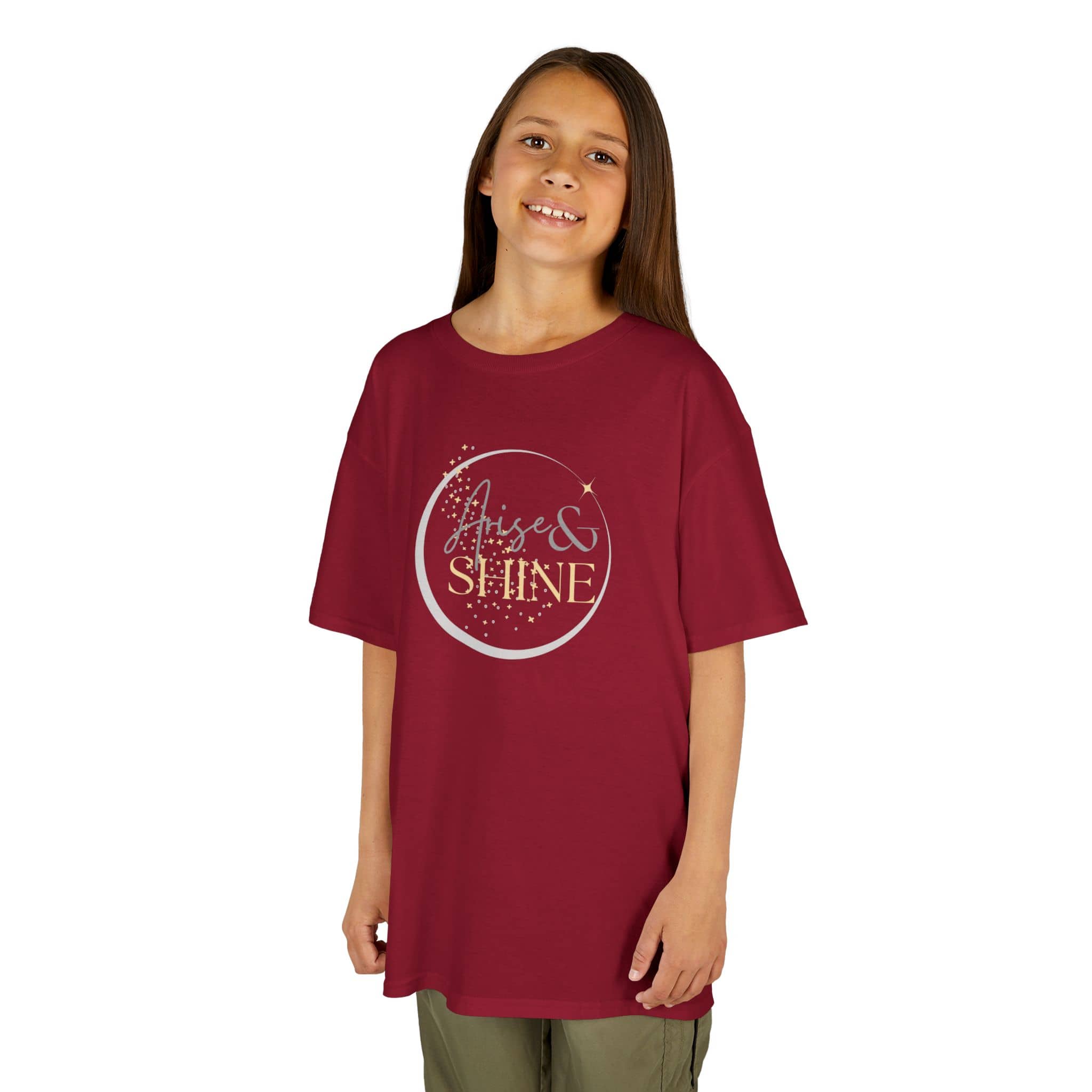 Girl wearing a maroon Scripture design junior shirt with Arise and Shine text and star graphic