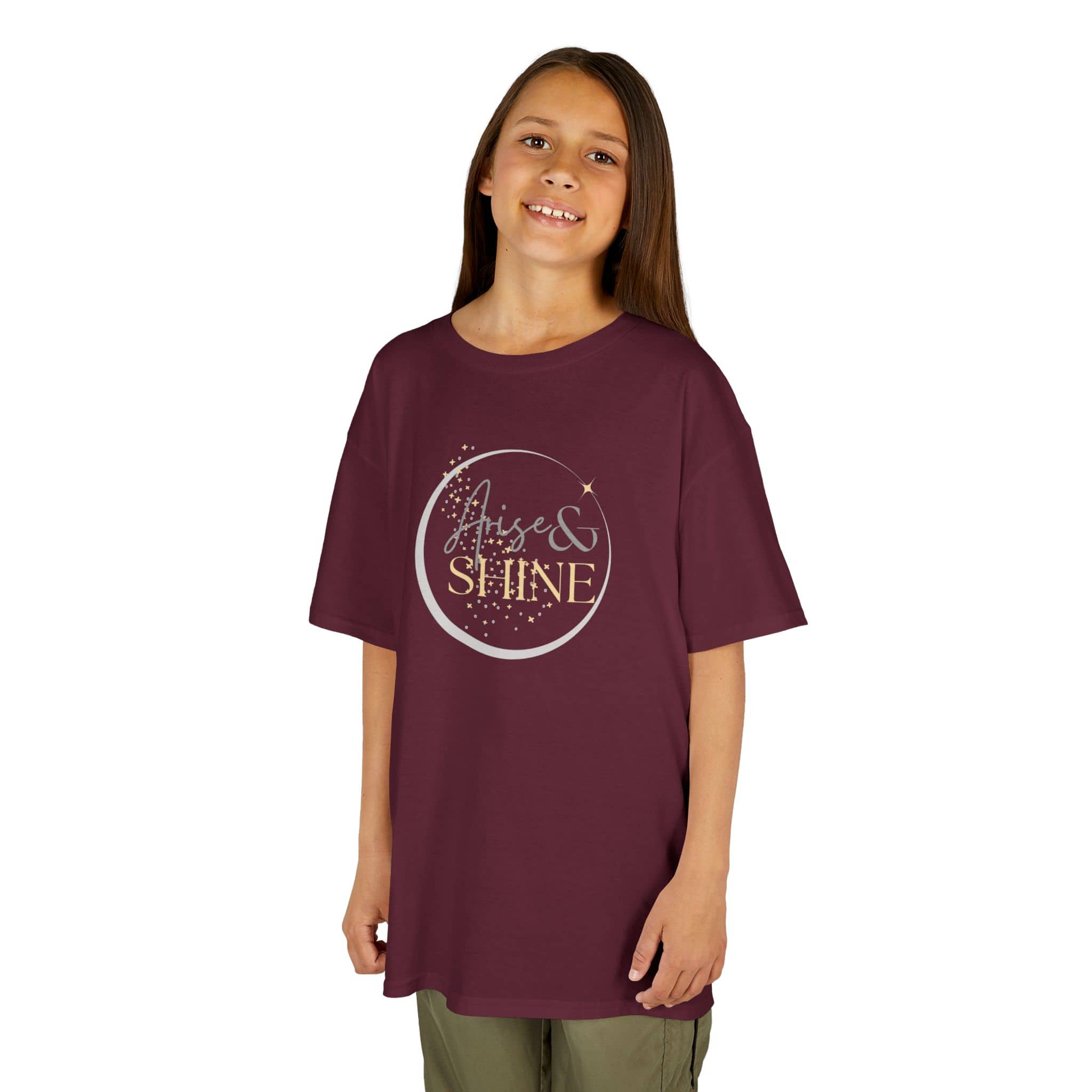 Smiling girl wearing a maroon Scripture design junior shirt with Arise and Shine text print
