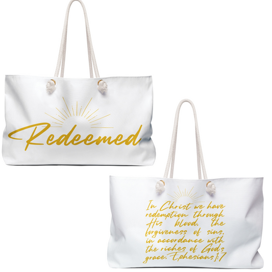 Scripture inspired travel bag with the word Redeemed and Ephesians quote in gold lettering
