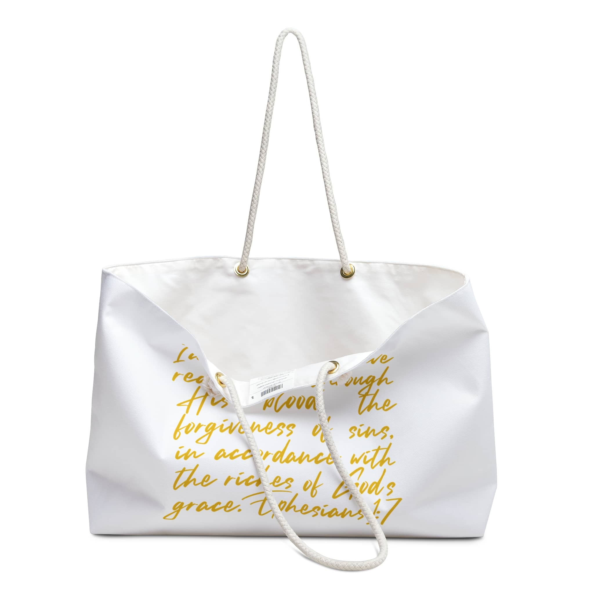 Scripture inspired travel bag in white with golden text and rope handles for stylish journeys