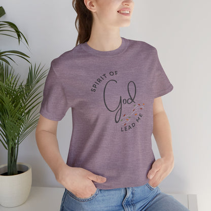 Woman wearing a purple Spirit Lead Me shirt with God inspired text and floral design printed on front