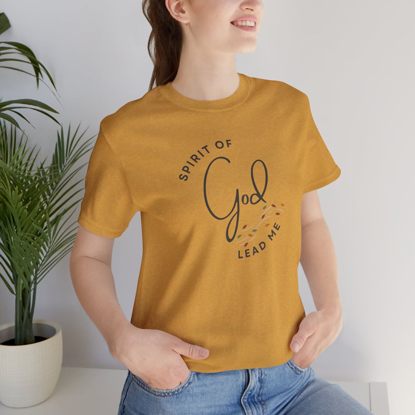 Spirit Lead Me shirt in mustard yellow worn by woman with casual jeans and relaxed pose