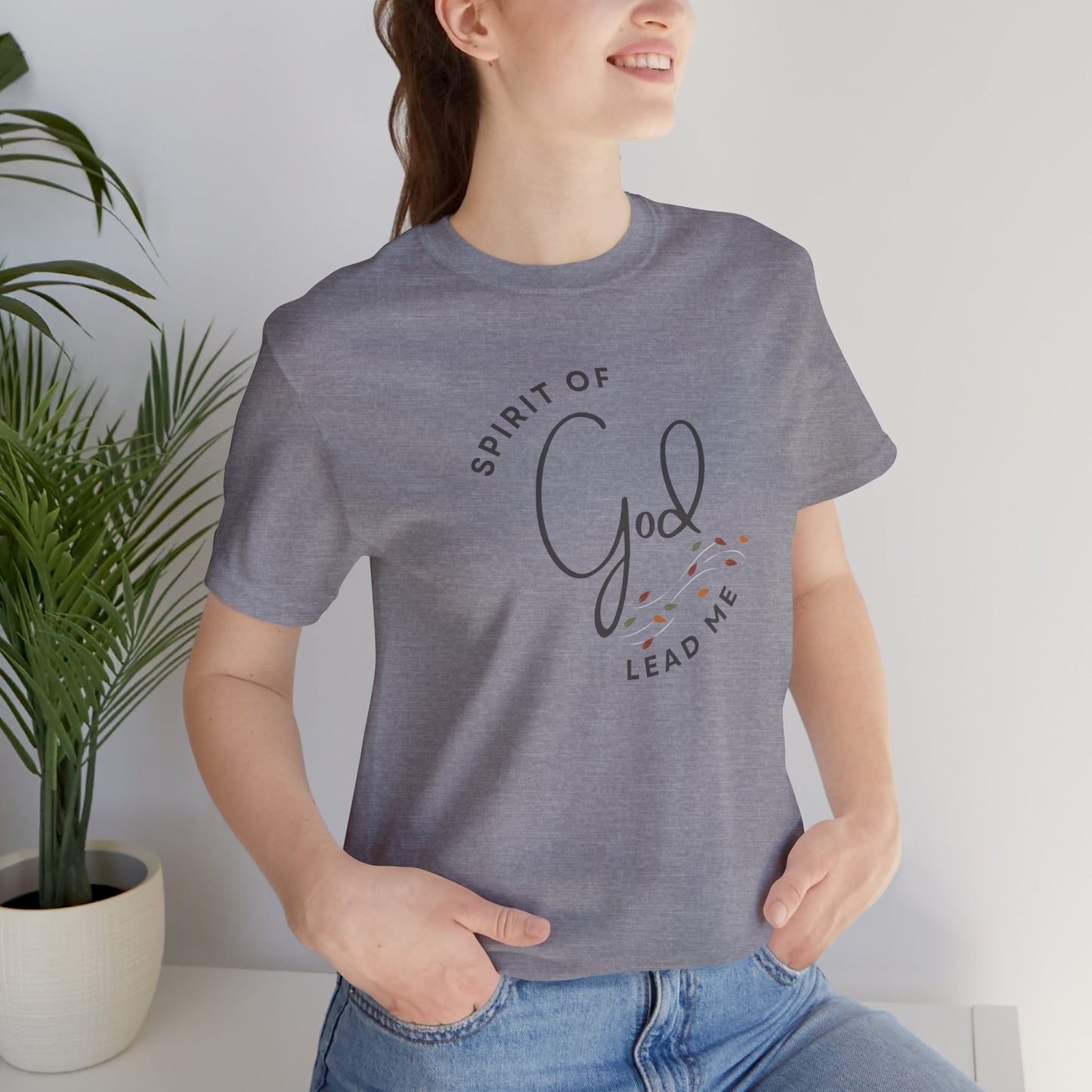 Gray Spirit Lead Me shirt with God lettering worn by a woman with hands in pockets from Logos