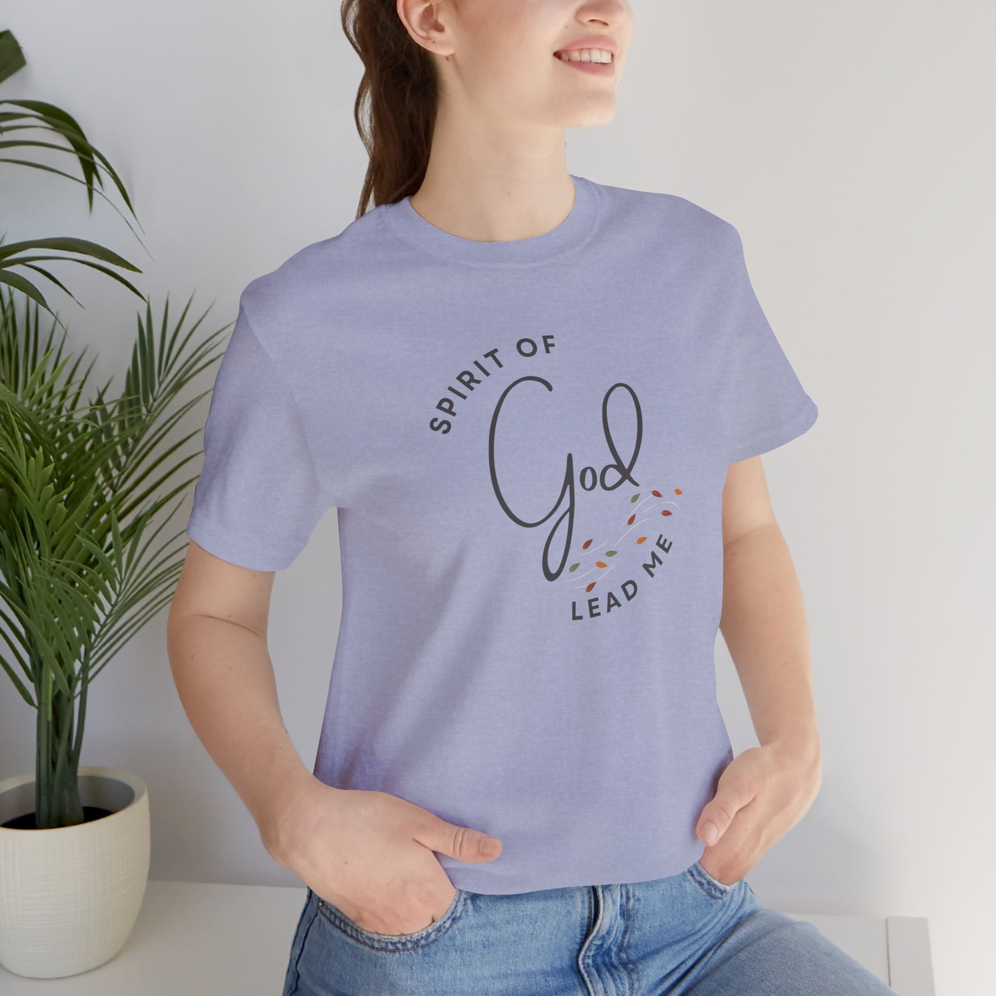Light purple Spirit Lead Me shirt by Logos worn by a woman with hands in pockets
