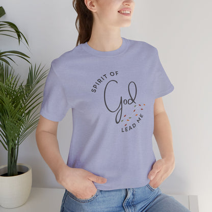 Light purple Spirit Lead Me shirt by Logos worn by a woman with hands in pockets