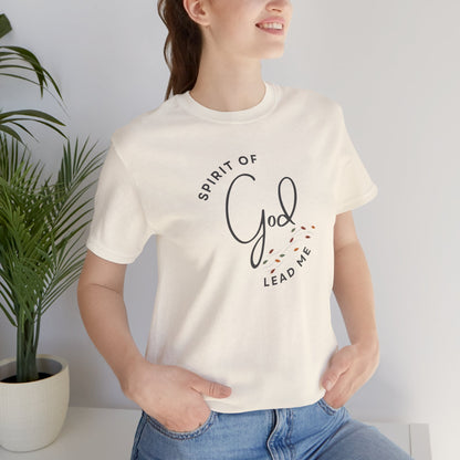 Woman wearing a white Spirit Lead Me shirt with text design and casual blue jeans indoors