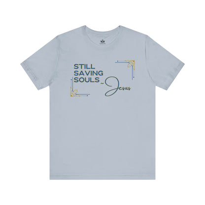 Light gray Logos Co. T-shirt with Still Saving Souls shirt design and Jesus text in decorative font