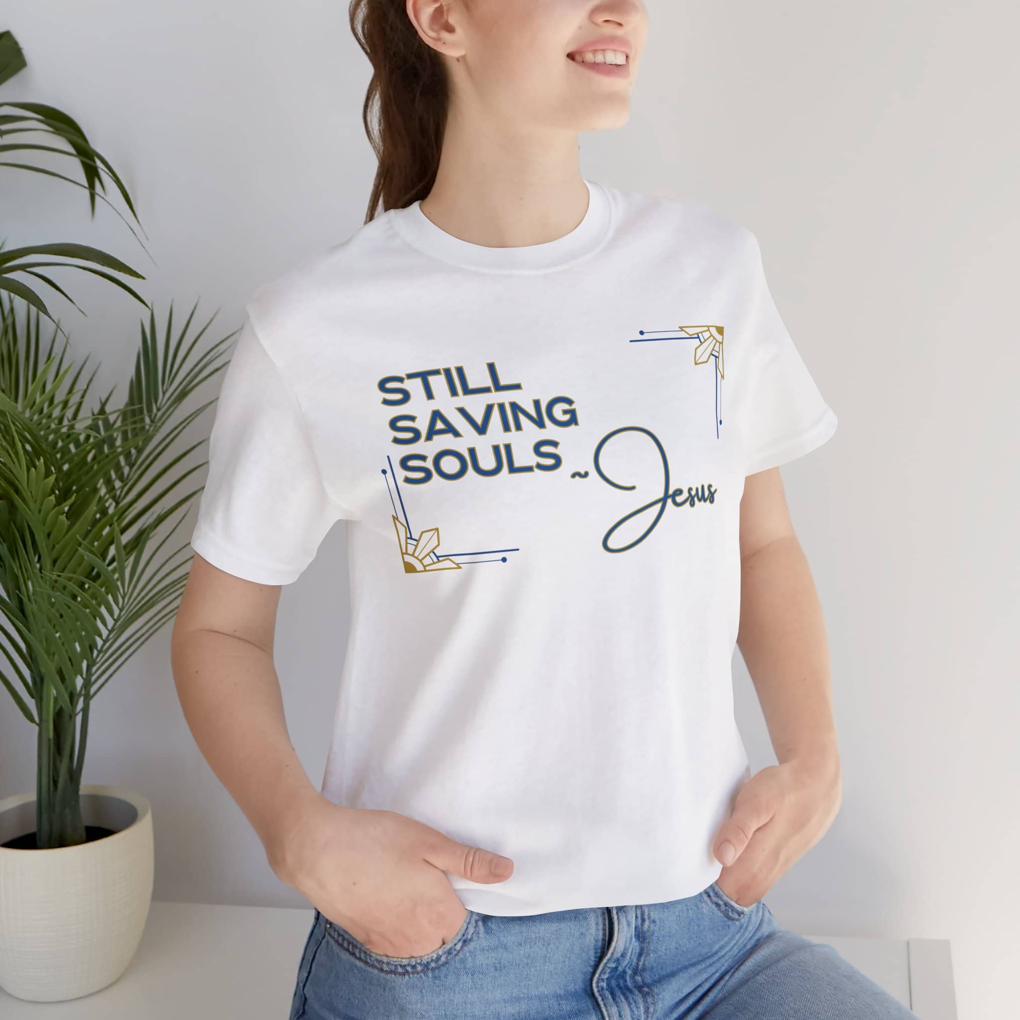 White Still Saving Souls shirt worn by woman with hands in pockets