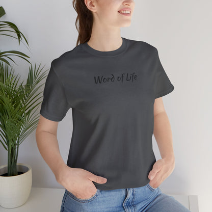 Woman wearing a black Word of Life Christian shirt by Logos with casual blue jeans indoors