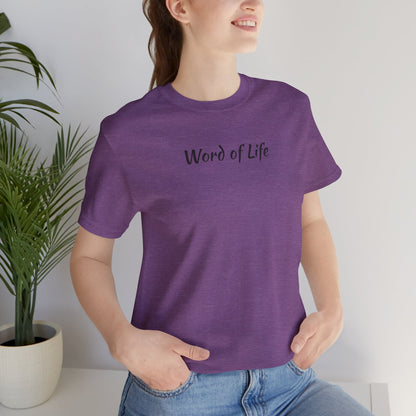 Purple Word of Life Christian shirt by Logos worn by woman with hands in pockets