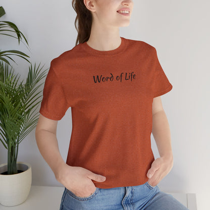 Word of Life Christian shirt in rust color worn by smiling woman with hands in pockets